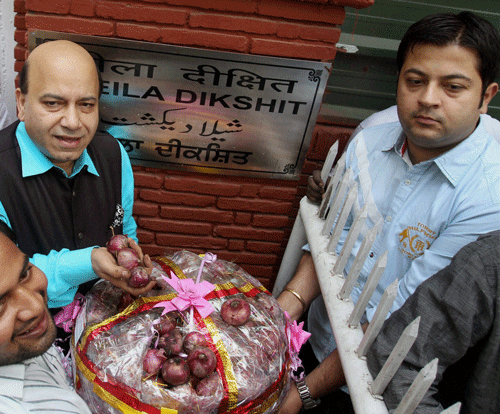 BJP leader Vijay Jolly arrives at the residence of Delhi CM Sheila Dikshit to greet her with a basket of onions on the occasion of Diwali festival, in New Delhi on Monday. PTI Photo