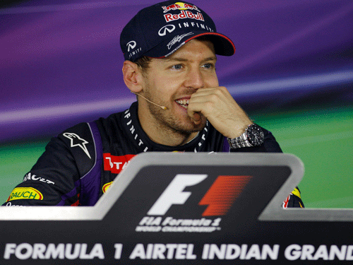 Red Bull driver Sebastian Vettel of Germany smiles at a press conference after winning the Indian Formula One Grand Prix and his 4th straight F1 world drivers championship at the Buddh International Circuit in Noida, India, Sunday, Oct. 27, 2013. AP Photo
