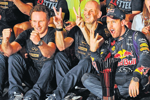 super seb: Red Bull's Sebastian Vettel (right) celebrates with technical director Adrian Newey (centre) and Team Prinicipal Christian Horner on Sunday. AFP
