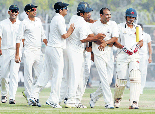 Haryana's Joginder Sharma (second from right) is congratulated by his team-mates after scalping Mumbai's Aditya Tare during their Ranji Trophy match in Lahli on Monday. Joginder took 5 for 16. PTI