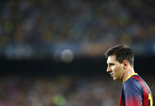 Barcelona's Lionel Messi looks on during a Spanish La Liga soccer match between Barcelona F.C. and Real Madrid at the Camp Nou stadium in Barcelona, Spain, Saturday, Oct. 26, 2013. AP