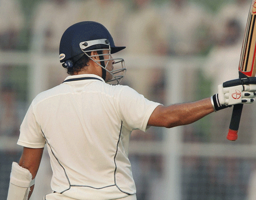 Mumbai's Sachin Tendulkar acknowledges the crowd on completing his half century during the Ranji trophy match against Haryana in Rohtak on Tuesday. Sachin is playing his last Ranji match. PTI Photo