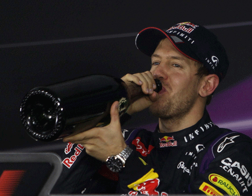 Red Bull driver Sebastian Vettel drinks champagne during a press conference after winning the Indian Formula One Grand Prix at Buddh International Circuit in Greater Noida on Sunday. PTI FILE Photo