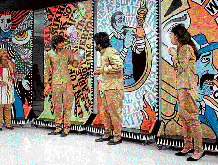 unusual: Actors perform in front of graffiti panels  during Quijote Wallah.