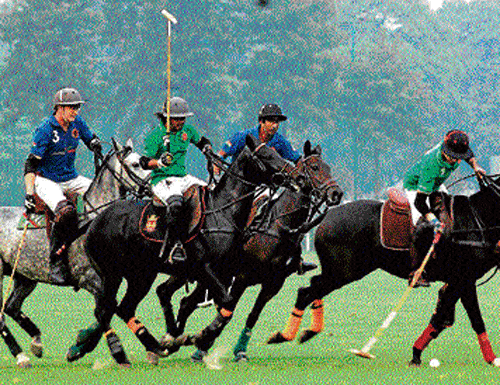 competitors Players from Jindal Panthers in blue and SSC in green battle for the Cavalry Gold Cup.