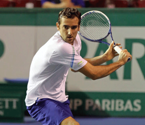 Croatian Marin Cilic backhands the ball to Netherland's Igor Sijsling during their first round match, at the BNP Masters tennis tournament, in the Paris Bercy stadium, Monday Oct. 28, 2013. AP Photo.