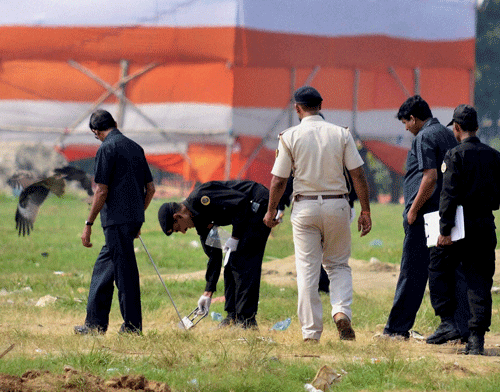 NSG commandos collecting samples from Gandhi maidan after it was rocked by bomb blasts during Narendra Modi's Hunkar rally on Monday in Patna. PTI File Photo