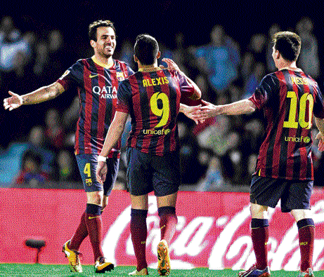 brilliant outing: Barcelona's Cesc Fabregas (left) celebrates after scoring against Celta Vigo on Tuesday. reuters