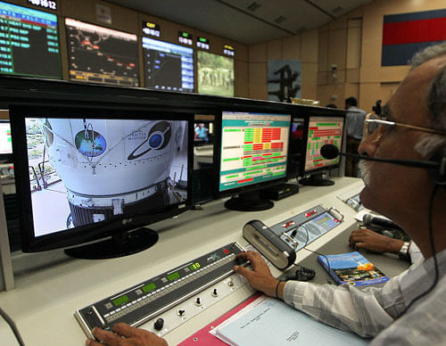 A technician monitors the functions of the Polar Satellite Launch Vehicle (PSLV-C25) at the Satish Dhawan Space Center at Sriharikota. Mars Orbiter Mission on board PSLV C25 is scheduled to be launched on November 5. PTI Photo