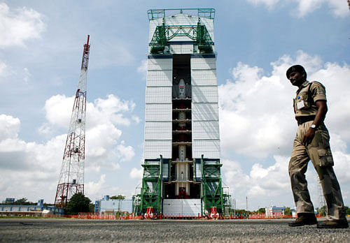 A paramilitary soldier walks past the Polar Satellite Launch Vehicle (PSLV-C25) at the Satish Dhawan Space Center at Sriharikota. India's Mars orbiter mission is scheduled to be launched by the Polar Satellite Launch Vehicle (PSLV-C25) on Nov. 5. AP Photo