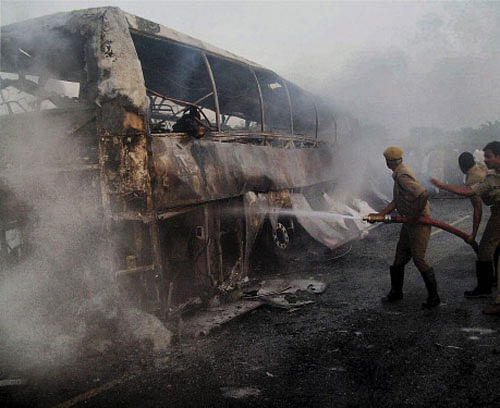 Firefighters trying to douse fire which engulfed a private bus coming to Hyderbad from Bangalore, near Mahabubnagar in Andhra Pradesh on Wednesday. PTI Photo