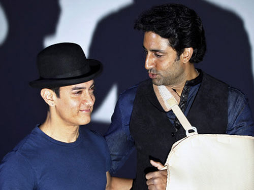 Bollywood actors Aamir Khan and Abhishek Bachchan attend a trailer launch of their film Dhoom 3 in Mumbai, Wednesday, Oct. 30, 2013. AP photo