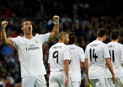 Real Madrid's Cristiano Ronaldo celebrates his third goal against Sevilla during their Spanish first division soccer match at Santiago Bernabeu stadium in Madrid October 30, 2013. REUTERS