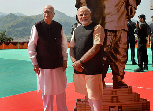Gujarat Chief Minister and BJP's Prime Ministerial candidate Narendra Modi with Senior leader L K Advani pose with the statue of Sardar Vallabhbhai Patel during the foundation laying ceremony of 'Statue of Unity' in Bharuch on Thursday. PTI Photo