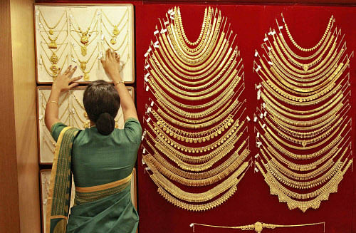 File photo of a saleswoman arranging a gold necklace inside a jewellery showroom in the southern Indian city of Kochi. Reuters.