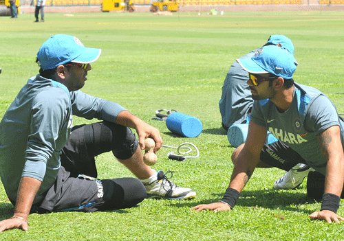 Indian Cricket team players Yuvraj Singh and Virat Kolhi streaching during their team nets practice on the eve of the seventh and final one day international match at Chinnaswamy stadium in Bangalore on Friday. DH  Photo