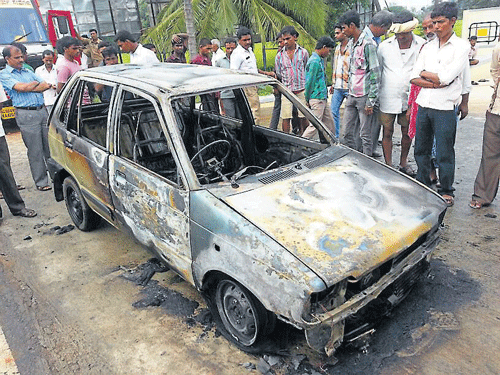 Kantharaj's car which caught fire on Mysore-Bangalore Road, on Monday.