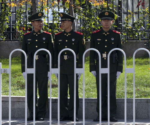 Chinese paramilitary policemen stand on duty in central Beijing ahead of the 205-member Central Committee's third plenum, Thursday, Nov. 7, 2013. Facing pressure to overhaul a worn-out growth model, China's leaders are promising dramatic changes at a weekend meeting that reform advocates hope will make history by unleashing a new wave of economic transformation. AP