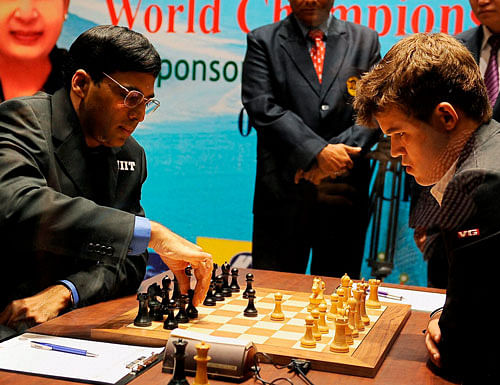Viswanathan Anand of India makes a move against Magnus Carlsen of Norway during their first match at FIDE World Chess Championship in Chennai on Saturday. PTI Photo
