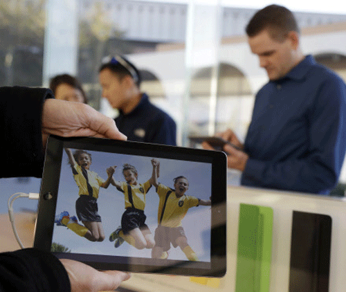 The new iPad Air is displayed on Friday, Nov. 1, 2013, in Stanford, Calif. Apple's iPad Air, a thinner, lighter and faster-running version of its previous large tablet computers, goes on sale Friday with a starting price of $499. The company also unveiled an updated version of its iPad Mini recently. It goes on sale sometime in November. AP Photo