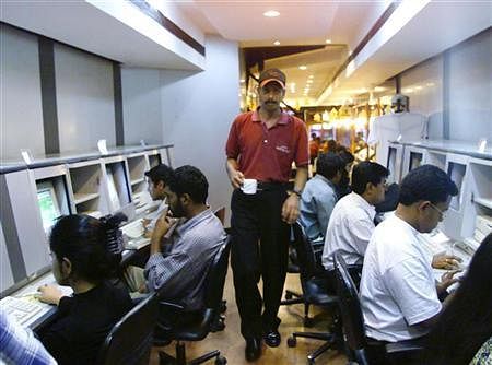 A waiter serves coffee to college students surfing the internet at a cafe in Bangalore. File photo Reuters