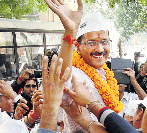 AAP convener Arvind Kejriwal waves to supporters after filing his nomination papers from the New Delhi constituency at Jamnagar House in New Delhi on Saturday.  PTI