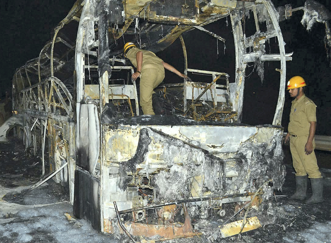 In the wake of recent bus blazes, the state Transport Department has set a three-month deadline for all Volvo buses to instal emergency exits failing which the bus operator will be penalised and buses seized. Firefighters inspect the remains of a charred bus which caught fire near Haveri district in Karnataka on Thursday. PTI Photo
