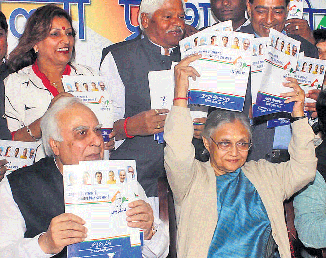 Delhi Chief Minister Sheila Dikshit, minister Kapil Sibal (left), Congress general secretary Shakeel Ahmad release Congress manifesto at DPCC office in New Delhi on Thursday.  DH Photo