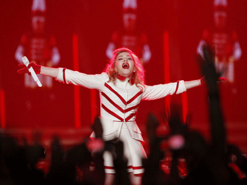 Singer Madonna performs at the Staples Center as part of her MDNA world tour in Los Angeles, California in this October 10, 2012 file photo. Madonna is the highest-paid musician in 2013 with estimated earnings of $125 million, easily surpassing singer Lady Gaga and veteran rockers Bon Jovi, Forbes magazine said on November 19, 2013. REUTERS