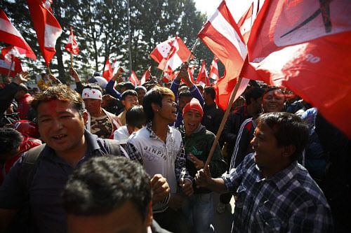 Supporters of the Nepali Congress Party cheer for their party as the Constituent Assembly Election scores are displayed on a screen outside the Constitution Assembly Building in Kathmandu November 21, 2013. Nepal's powerful Maoists, trailing in this week's election, called for an end to vote counting on Thursday, risking further political instability in the small Himalayan nation. The ballot will elect an assembly, which will act as parliament, and draft a constitution aimed at ending years of instability which has seen five governments in as many years. REUTERS