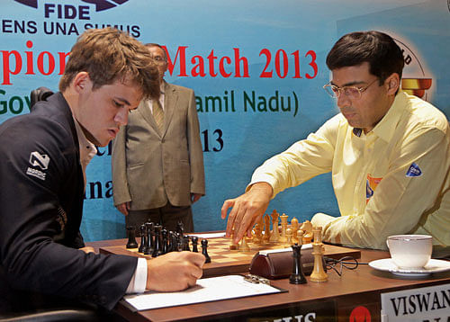 Viswanathan Anand of India makes a move against Magnus Carlsen of Norway during their ninth match at FIDE World Chess Championship in Chennai on Thursday. PTI Photo