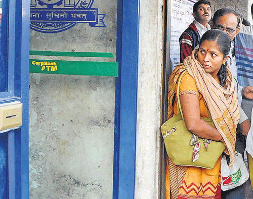 fear-struck: A woman looks at the ATM kiosk where Jyothi Uday was attacked, in Bangalore on Thursday. dh photo