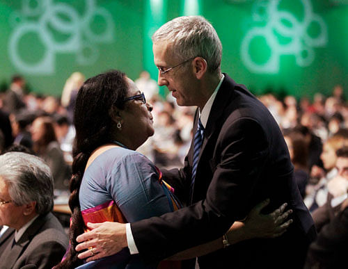 India's Environment Minister Jayanthi Natarajan embraces U.S. climate envoy Todd Stern at the closing session during the 19th conference of the United Nations Framework Convention on Climate Change (COP19) in Warsaw November 23, 2013. REUTERS