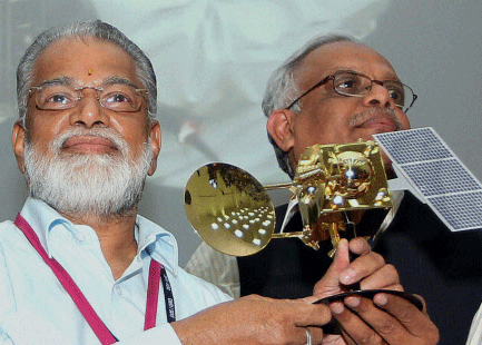 File picture of ISRO Chairman K Radhakrishnan along with Mars Orbiter Mission Project Director S Arunan with a model of the Mars, after successfully launch of India's first mission to Mars, at Sriharikota in Andhra Pradesh recently. The mission on Monday suffered a glitch ch as it failed to achieve the targeted apogee (farthest distance from Earth) of one lakh km during the fourth orbit raising operation in the early hours. PTI Photo