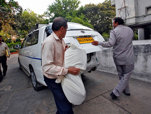 File photo of officials carrying a bag of documents after conducting raid as part of probes into the AgustaWestland bribery case in New Delhi. Reuters