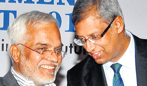 KSPCB Chairman Dr Ayi Vaman N Acharya speaks with CII Karnataka State Council Chairman Soumitra Bhattachara in Bangalore on Thursday. DH Photo