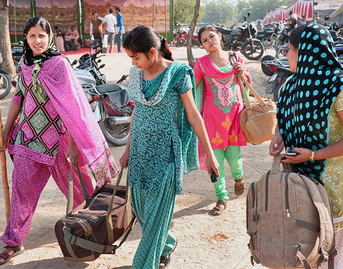 Women security personnel leave for poll duty from a distribution centre in Bikaner on Friday ahead of Rajasthan Assembly elections. PTI Photo