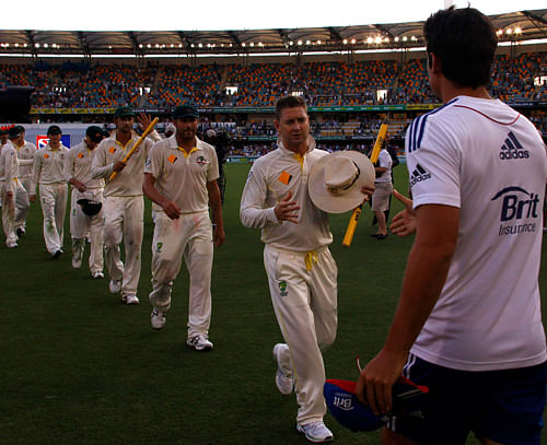 Australia's Clarke prepares to shake hands with England's captain Cook after winning the first Ashes cricket test match against England, in Brisbane. England face a critical challenge to their four-year Ashes reign in the second Test against Australia starting in Adelaide on Thursday against a re-energised home team looking to drive home their advantage. Reuters File Photo.