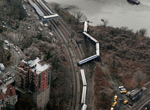 The New York commuter train which derailed at the weekend leaving four people dead was traveling at nearly three times the recommended speed limit when it hurtled off the tracks, federal investigators have said. AP Photo