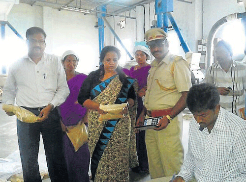 Officials examine wheat packets at Rashmi Industries, in Mysore, on Tuesday. dh photo