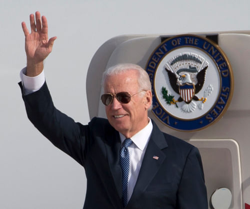 U.S. Vice President Joe Biden waves as he walks out of Air Force Two at the airport in Beijing December 4, 2013. Biden should not expect to make much progress in defusing tensions over the East China Sea if he plans to repeat 'erroneous and one-sided remarks' on the issue when he visits China, a top state-run paper said on Wednesday. Beijing's decision to declare an air defence identification zone in an area that includes disputed islands has triggered protests from the United States, Japan and South Korea and dominated Biden's talks in Tokyo on Tuesday. REUTERS
