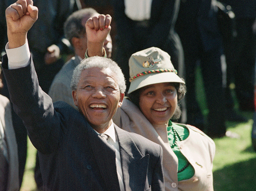 In this July 7, 1991, file photo, newly-elected African National Congress President Nelson Mandela and his wife, Winnie, greet the crowd after arriving at a rally and a week-long national ANC conference held inside South Africa for the first time in 30 years. South Africa's President Jacob Zuma said, Thursday, Dec. 5, 2013, that Mandela has died. He was 95. (AP Photo)