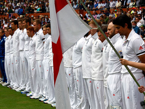 England's captain Alastair Cook (R) and his team stand as they observe a minute of silence to commemorate former South African President Nelson Mandela's death before starting the second day's play in their second Ashes cricket test against Australia at the Adelaide Oval December 6, 2013. South African anti-apartheid hero Mandela died aged 95 at his Johannesburg home on Thursday after a prolonged lung infection, plunging his nation and the world into mourning for a man hailed by global leaders as a moral giant. REUTERS