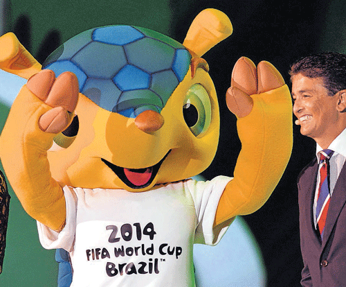 2014 World Cup mascot Fuleco and Brazilian legend Bebeto during the draw ceremony on Friday. REUTERS.