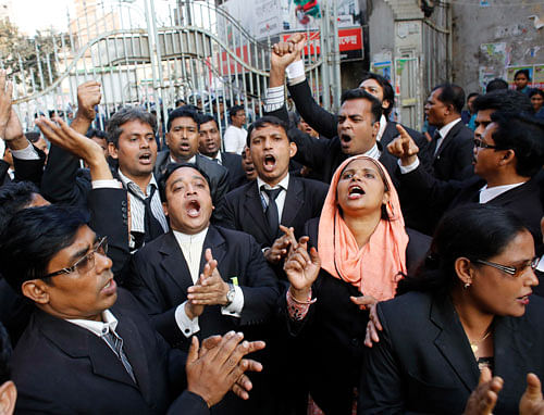 Lawyers loyal to Bangladesh Nationalist Party shout slogans during a hearing of their leader Sadeque Hossain Khoka in front of a court in Dhaka December 5, 2013. A Dhaka court has granted police two days remand to Bangladesh Nationalist Party (BNP) leader Sadeque Hossain Khoka involving the torching of a bus. At least 19 people, including a journalist, a police officer and a lawyer, sustained burn injuries after protestors set fire to the passenger bus on November 28 evening in Dhaka, local media reported. REUTERS