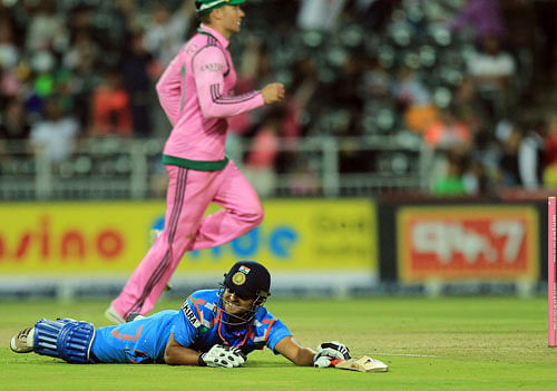India's batsman Suresh Raina, lies on the pitch after being run out for 14 runs during their 1st One Day International cricket match against South Africa at Wanderers stadium in Johannesburg, South Africa, Thursday, Dec. 5, 2013. AP Photo