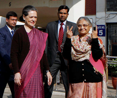 UPA Chairperson Sonia Gandhi with Delhi Chief Minister Sheila Dikshit after casting votes for Delhi Assembly elections at Nirman Bhawan polling station in New Delhi. PTI Photo