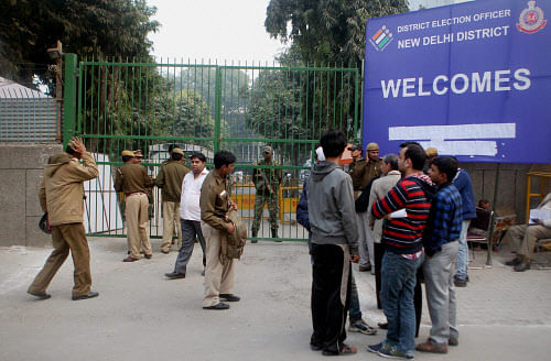 Security personals stand guard at a counting center of a New Delhi area on Saturday. PTI Photo
