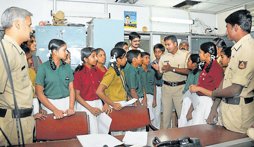 Students interact with police officials during their visit to police control room, in Mysore, on Saturday. DH Photo