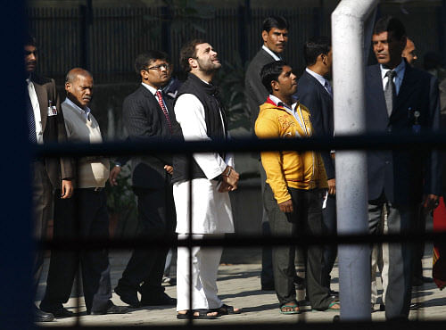 Rahul Gandhi waits in a queue to cast his vote outside a polling station during the state assembly elections in New Delhi. Reuters.